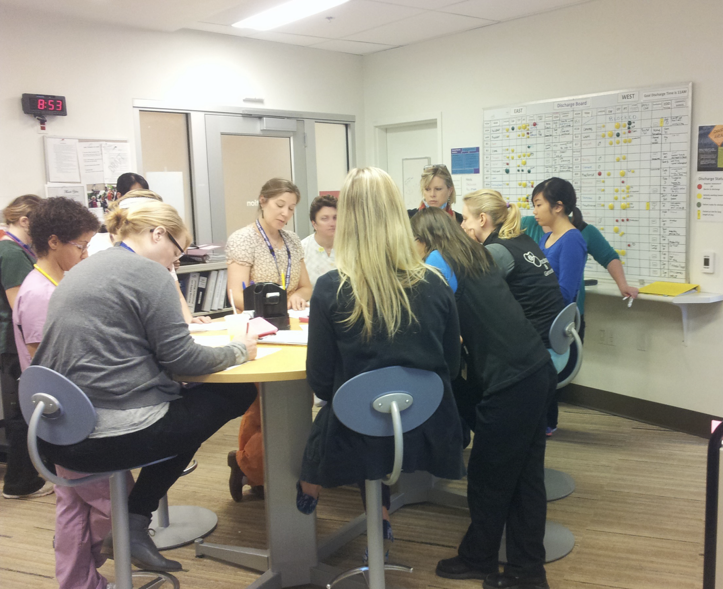 Care team gathered at the discharge board during rounding